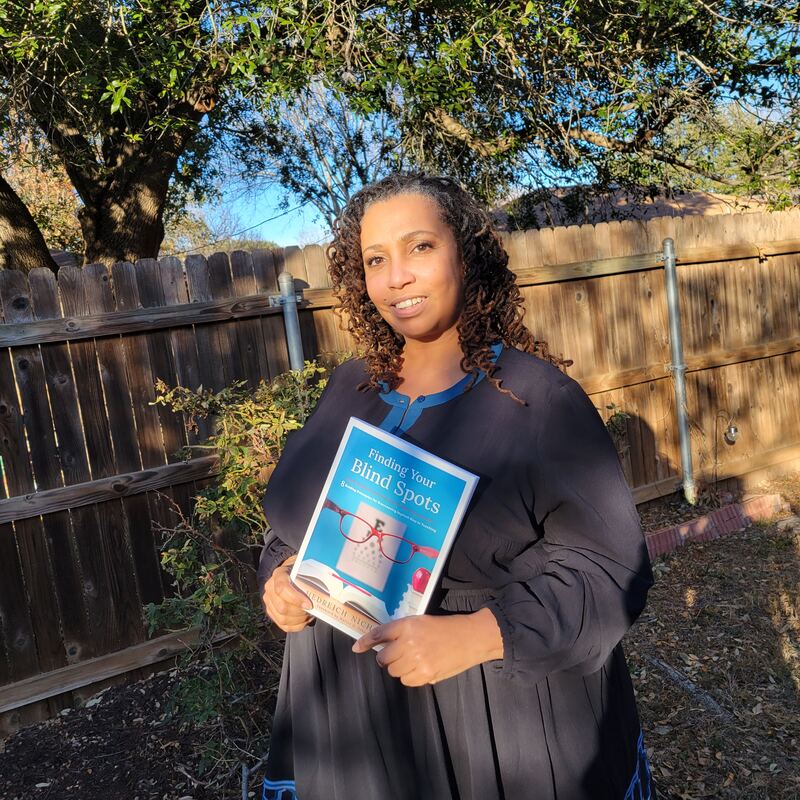 Hedreich outdoors holding her book