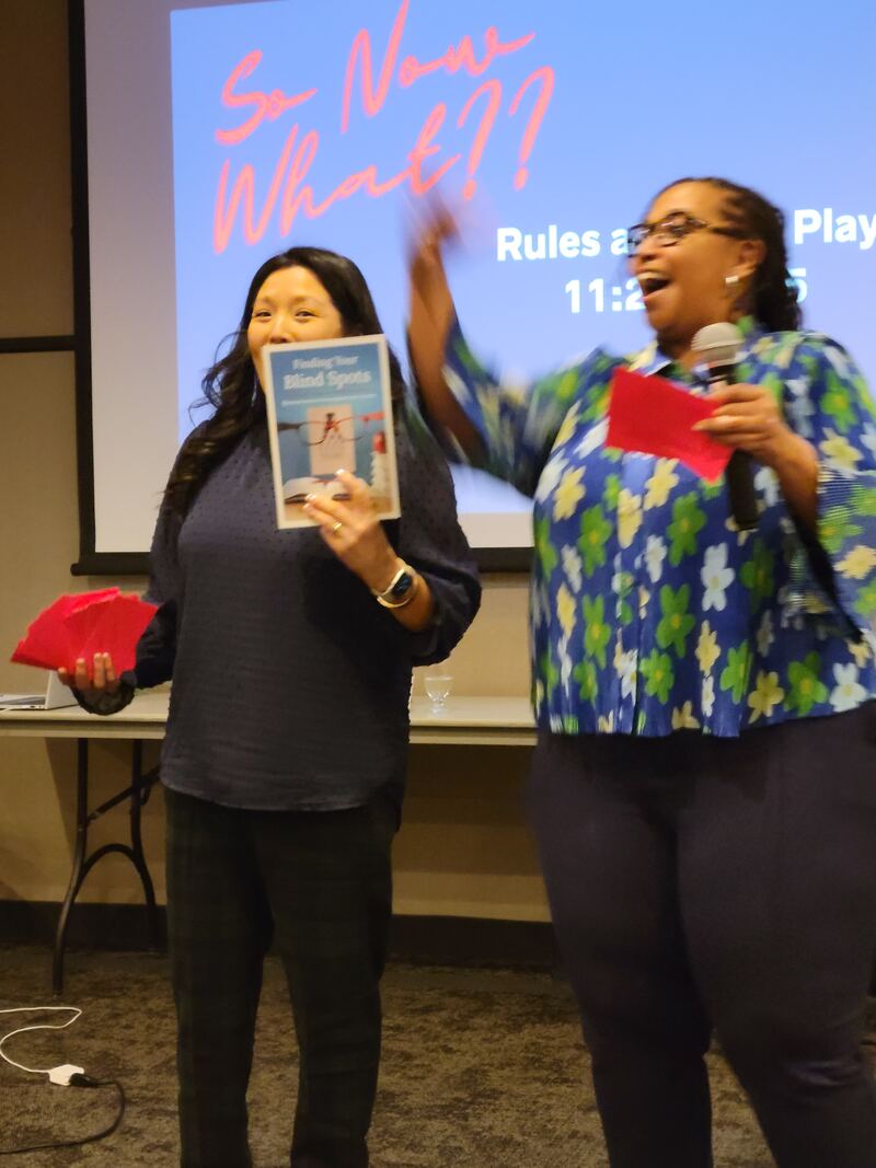 Hedreich celebrating with an educator holding her book