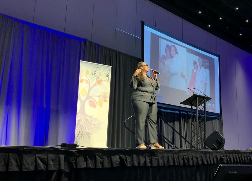 Hedreich Nichols speaking on a conference stage