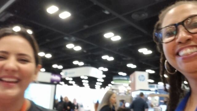 Hedreich talking with an educator on an expo floor