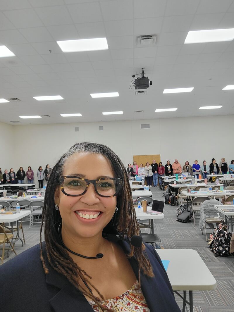 Hedreich smiling in front of a full workshop room